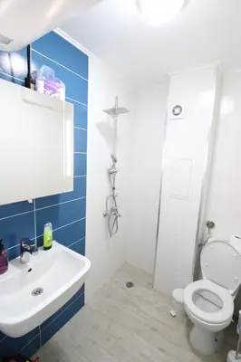 a bathroom with a white toilet and a sink at Modern 1BR Apartment Plovdiv City Center Parking in Plovdiv