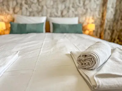 a rolled up towel on top of a bed at One-Bedroom Apartment next to Mall Plovdiv with Free Street Parking in Plovdiv