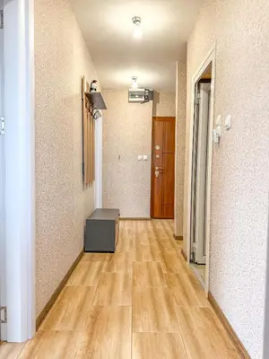an empty room with a hallway with wooden floors at One-Bedroom Apartment next to Mall Plovdiv with Free Street Parking in Plovdiv