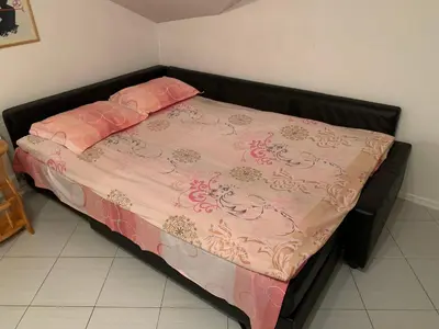 a bed with a pink blanket and pink pillows on it at Iglika 2 Top Floor apartment in Borovets