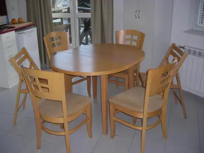 a wooden table and chairs in a kitchen at Iglika 2 Top Floor apartment in Borovets