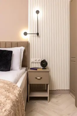 a bedroom with a bed and a night stand with a lamp at Royal Garden apartment with Private Parking in Plovdiv