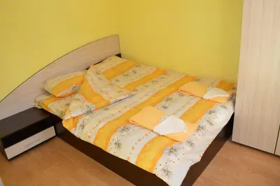 a bed with towels and pillows on it in a room at Guest House Rainbow in Cherni Osŭm