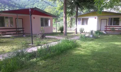 a small house in a yard next to a field at Guest House Rainbow in Cherni Osŭm