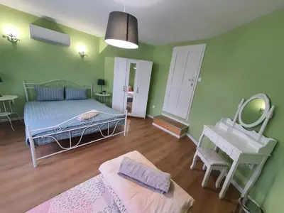 a bedroom with a bed and a mirror and a sink at Guest House Old City Plovdiv in Plovdiv