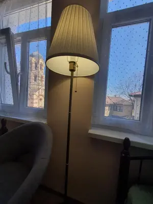 a lamp in the corner of a room with two windows at Guest House Old City Plovdiv in Plovdiv