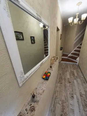 a large mirror on a wall in a hallway at Guest House Old City Plovdiv in Plovdiv