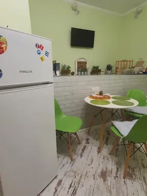 a kitchen with a table and a refrigerator at Guest House Old City Plovdiv in Plovdiv