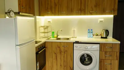 a kitchen with a white refrigerator and a washing machine at The BlackPeak View Apartment in Sofia