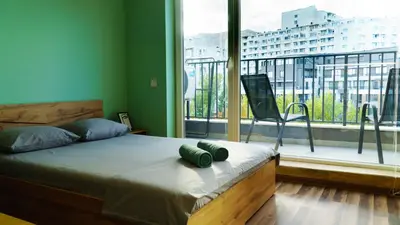 a bedroom with a bed and a large window at The BlackPeak View Apartment in Sofia