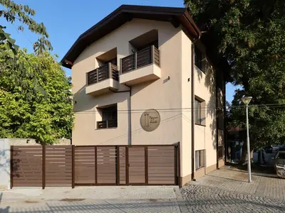 a building with a wooden gate and a fence at Portata in Plovdiv