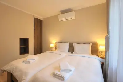 a bedroom with a large white bed with towels on it at Portata in Plovdiv