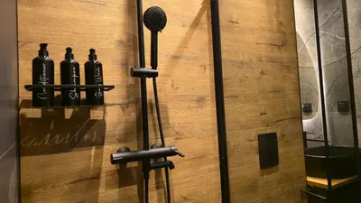 a door with a microphone on a wooden wall at LUXURY Designer Apt I Meters to Gondola Lift I Sleeps 6 I Pool & Parking I in Bansko