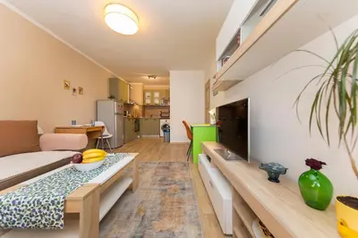 a living room with a couch and a table at Lovely Central 1 Bedroom Condo in Sofia in Sofia