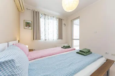 a bedroom with two beds and a window at Lovely Central 1 Bedroom Condo in Sofia in Sofia