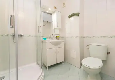 a bathroom with a toilet and a sink and a shower at Lovely Central 1 Bedroom Condo in Sofia in Sofia