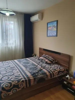 a bedroom with a bed with a blanket and a window at Sofia escape in Sofia