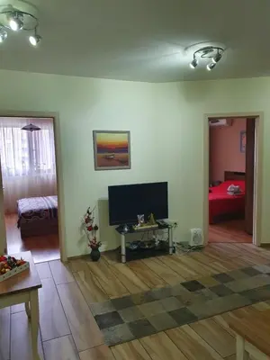 a living room with a flat screen tv and a table at Sofia escape in Sofia