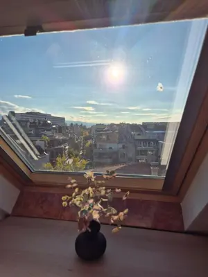 a large window with a view of a city at Cozy Studios Plovdiv in Plovdiv