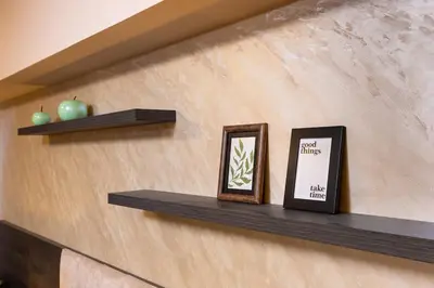 a shelf with two pictures on a wall at Warm and Spacious 1BR Apt - Brownie in Plovdiv