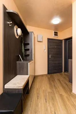 a room with a black door and a wooden floor at Warm and Spacious 1BR Apt - Brownie in Plovdiv