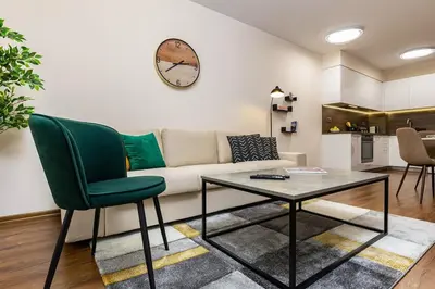 a living room with a couch and a table at Downtown apt Atelier 53 - Free Parking in Plovdiv