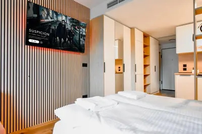 a bedroom with a bed and a television on a wall at Little Sugar Home in Sofia