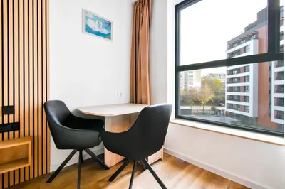 a table and two chairs in a room with a window at Little Sugar Home in Sofia