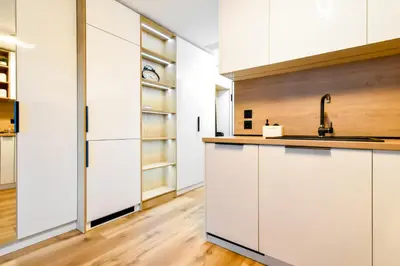 a kitchen with white cabinets and a sink at Little Sugar Home in Sofia