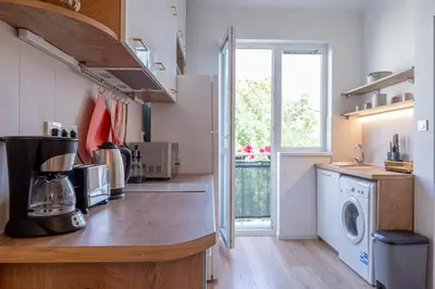 a kitchen with a washer and dryer on a counter at Old Town Bijou in Sofia