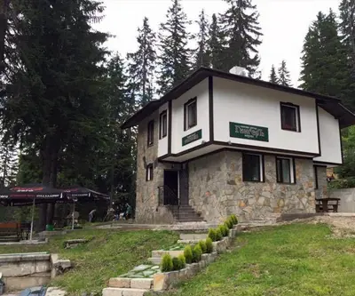 a large stone building in the middle of a park at Семеен хотел Гингеръ in Pamporovo