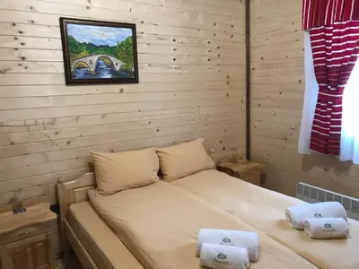 a bedroom with a bed with two towels on it at Семеен хотел Гингеръ in Pamporovo
