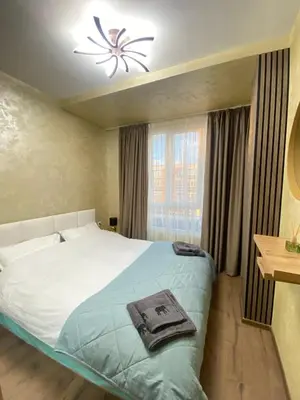 a bedroom with a large bed and a window at Beautiful 2BD Apartment with Large Terrace and Free Parking in Plovdiv