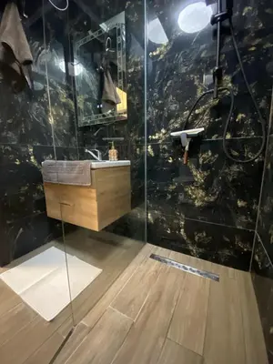 a bathroom with a sink and a glass shower at Beautiful 2BD Apartment with Large Terrace and Free Parking in Plovdiv