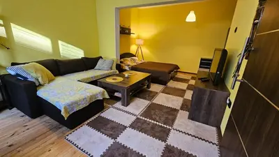 a living room with a couch and a table at Cozy spot at the heart of Sofia in Sofia