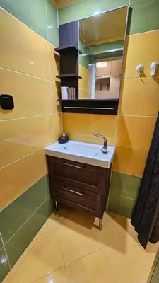 a bathroom with a sink and a mirror at Cozy spot at the heart of Sofia in Sofia