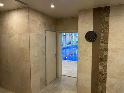 a clock on a wall in a room with a pool at Devin River in Devin