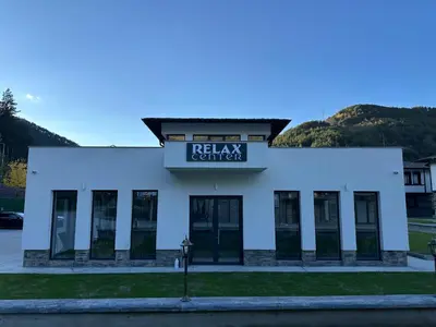 a white building with a sign that reads relax center at Devin River in Devin