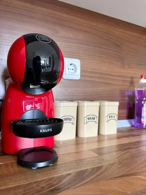 a red blender sitting on top of a wooden floor at Snow Apartment Bansko Home2Host in Bansko