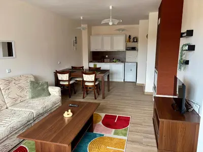 a living room with a couch and a table at Snow Apartment Bansko Home2Host in Bansko