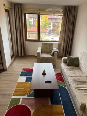 a living room with a couch and a coffee table at Snow Apartment Bansko Home2Host in Bansko