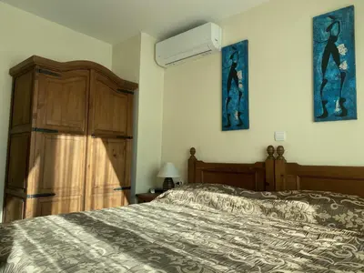 a bedroom with a bed and a dresser at Kandahar Apartment - top location in Bansko
