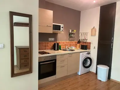 a small kitchen with a sink and a washer at Kandahar Apartment - top location in Bansko