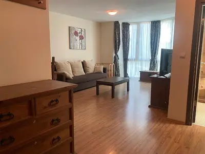 a living room with a couch and a tv at Kandahar Apartment - top location in Bansko