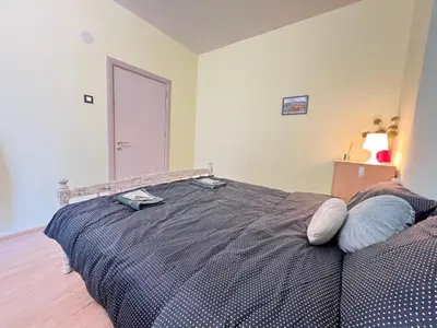 a bedroom with a bed with two pillows on it at Bogota Central Apt w Office Space and Wifi near Metro in Sofia