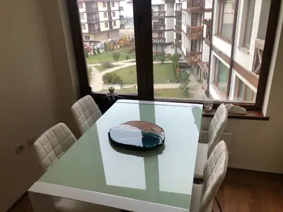 a cake sitting on a table in a room with a window at Artistic Neon Apartment in Bansko