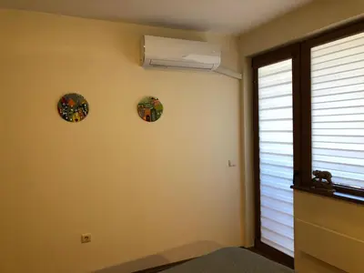 a room with two plates on the wall and a window at Artistic Neon Apartment in Bansko