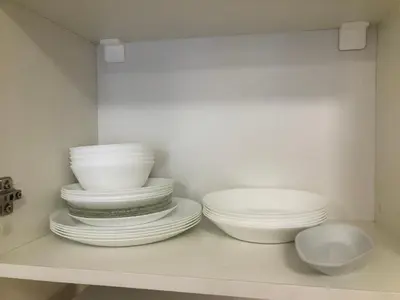 a stack of plates and bowls on a shelf at Artistic Neon Apartment in Bansko