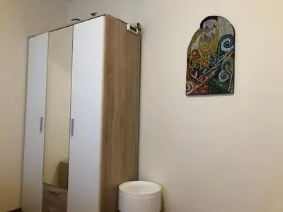a bathroom with a toilet and a mirror at Artistic Neon Apartment in Bansko