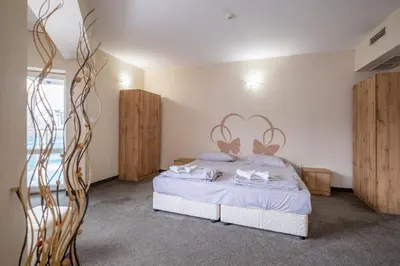 a bedroom with a bed with white sheets at Julia rooms in Sofia